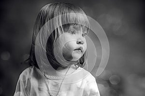 Black and white portrait of a serious little girl