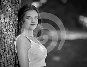 Black and white portrait of stunning young woman in park