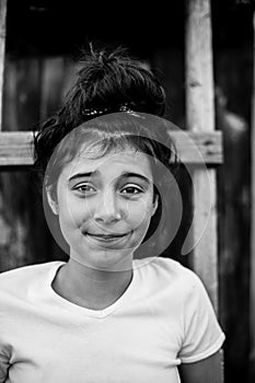 Black and white portrait of a teenage girl outdoors.