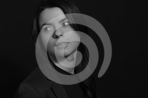 Black and white portrait of a young brunette woman in a studio