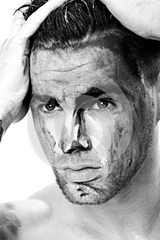 Black and white portrait of a young man with streaks of paint on face . fantasy art of makeup