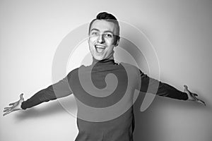 Black and white portrait of a young open minded man in a turtleneck jumper