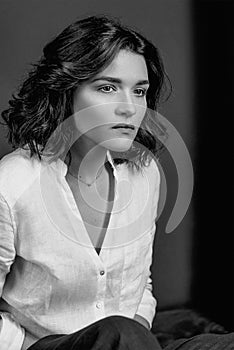 Black and white portraite of young, beautiful sad woman actress with short brown hair