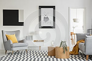 Black and white poster of dog on the wall of fashionable living room interior with two wooden coffee tables with flowers photo