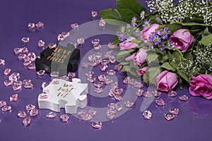 Pink roses surrounded by pink glass heart and black and white puzzle pieces with reflections