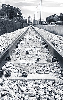 Black and white railway leading to industry