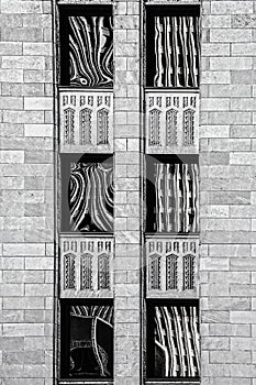 Black and white rendering of art deco building with abstract reflections in six windows - close-up