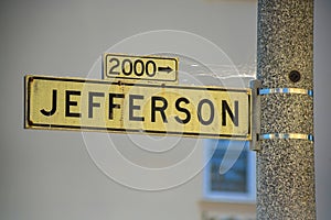 Black and white road sign on street lamp that say Jefferson in historic districts of downtown san francisco california