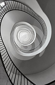 Black and white round spiral staircase with black railings top view