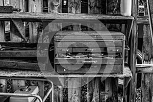 black & white rusty old toolboxes in shed