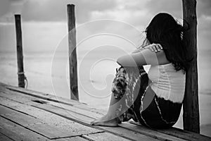 Black and white of Sad and lonely woman sitting alone