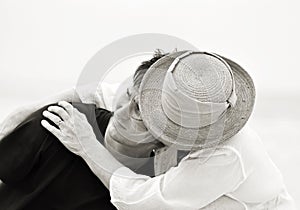 Black white sad mother holding her son in troubled times isolated pale background