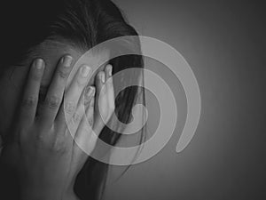 Black and white of Sad woman sitting alone in a empty room.