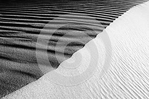 Black and White Sand beach macro photography. Texture of black and whote sand for background. Close-up macro view of volcanic sand photo