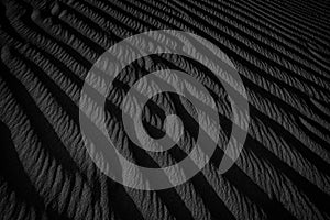 Black and White Sand beach macro photography. Texture of black and whote sand for background. Close-up macro view of volcanic sand photo