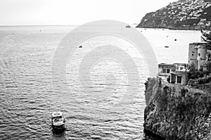 Black and white scenery of Tyrrhenian sea bay near Fiordo di Furore and Positano mountains region in Campania. Boats floating on