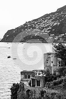 Black and white scenery of Tyrrhenian sea bay near Fiordo di Furore and Positano mountains region in Campania. Boats floating on photo