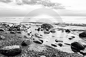 Black and white sea. Waves hitting in rocks