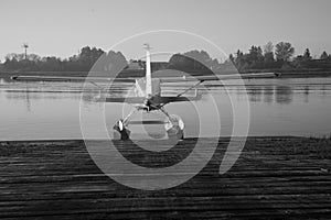 Black and white seaplane ready for flight water background