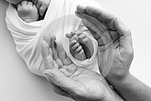 Black and white shade beautiful shape hands mother, hold tiny newborn baby feet