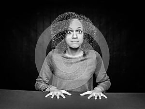 Black and White Shocked Young Girl Leaning on her Hands