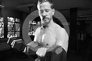 Black And White Shot Of Bare Chested Man Lifting Weights