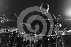 Black And White Shot Of Drummer Playing Drum Kit In Studio