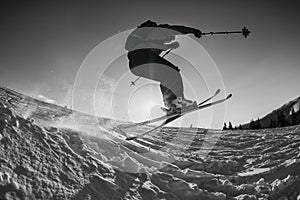 Black and white shot of free skier jumping