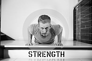 Black And White Shot Of Man In Gym Doing Press-Ups