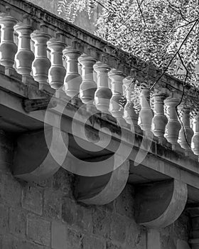 Black and white shot of a railing of a bridge