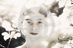 Smiling young man covered of overexposed leaves photo