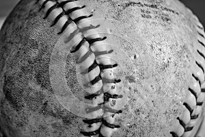 Black and white shot of a softball that has been chewed