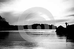 Black and white silhouette of person on Beach Jetty