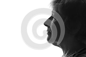 Black and white silhouette of a profile of an old woman on an isolated background