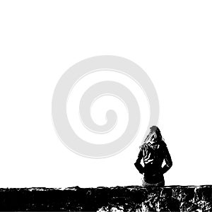 Black and white silhouette of sitting woman alone