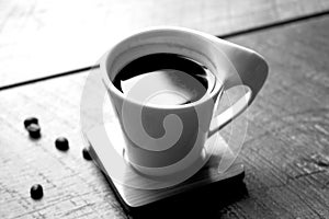 Black and white small coffee cup of expresso with beans