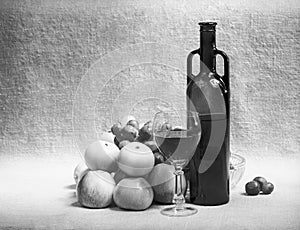 Black and white still-life with wine and fruit