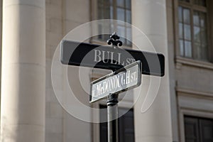 Black and white street signs on the corner of Bull Street and McDonough Street in Savannah Georgia