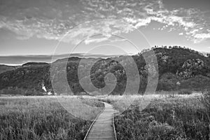 Black and white Stunning Autumn landscape sunrise image looking towards Borrowdale Valley from Manesty Park in Lake District with