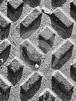 black and white surface texture of a manhole grate