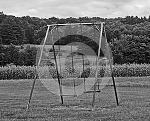 A black and white of a swing set