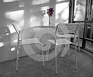 Black and white table set with purple dried flower in vase