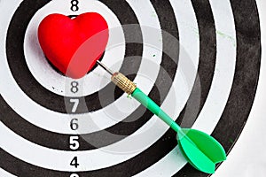 Black white target with dart in heart love symbol as bullseye