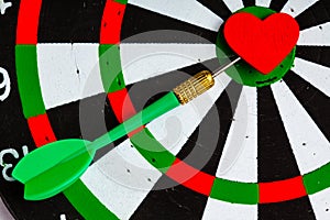 Black white target with dart in heart love symbol as bullseye