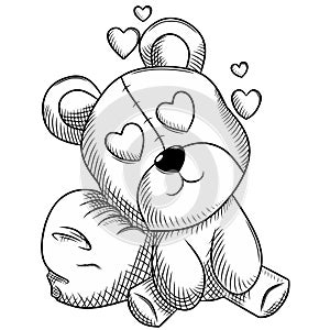 Black and white teddy bear resting on a love pillow