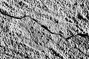 Black and white texture of a concrete wall with a crack