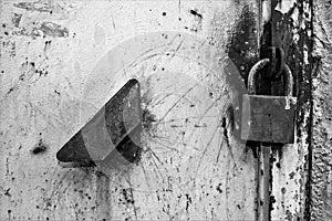 Black and white texture of door with padlock and handle