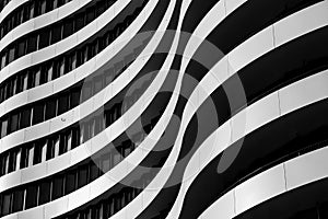 Black and white tone,curvature facade with black windows and white aluminium panels in wavy shape.