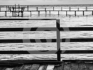 Black and white tone of wooden bridge in the sea