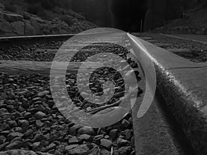 Black and white train tracks seen from below